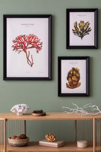 The stylish boho composition at living room interior with wooden console and elegant personal accessories. Mock up poster. Green wall.  Home decor. Template.